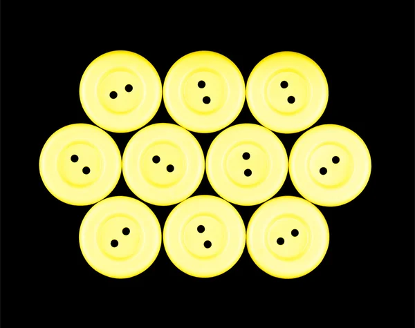 Bottoni gialli isolati su sfondo nero — Foto Stock