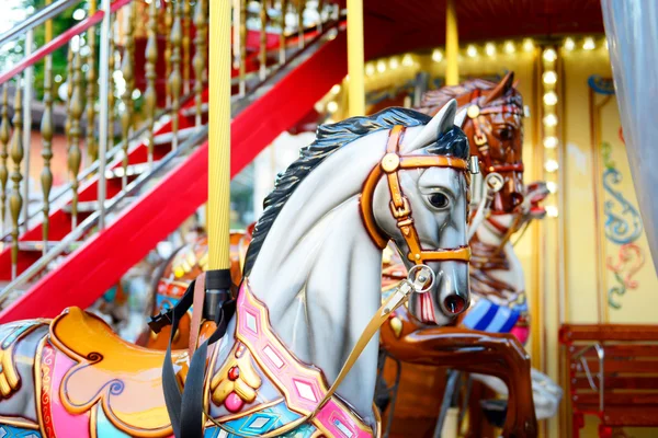 Children carousel running horses — Stock Photo, Image