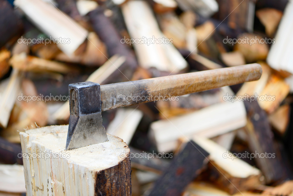 Old axe on a firewood background