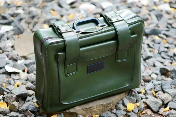 Green suitcase on the rocks — Stock Photo, Image