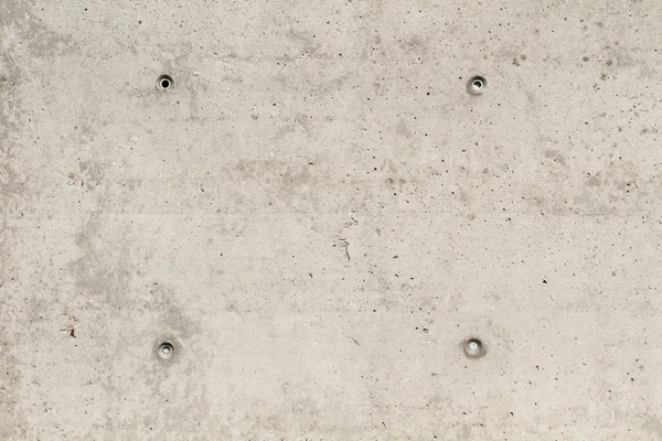 Concrete surface with four squared boreholes — Stock Photo, Image