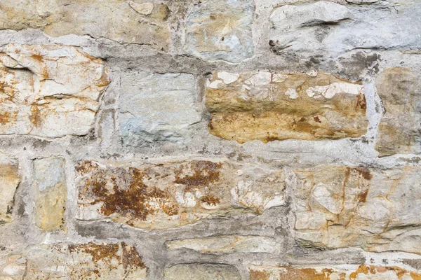 Stone wall outside with yellow stones and cement — Stock Photo, Image
