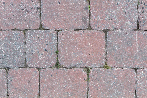 Kopfsteinpflaster einer Straße in Rot und Grau — Stockfoto