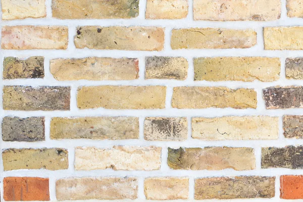 Brick wall with yellow and red stones — Stock Photo, Image