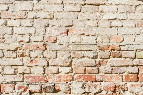 Bedraggled brick wall in dusted yellow — Stock Photo, Image