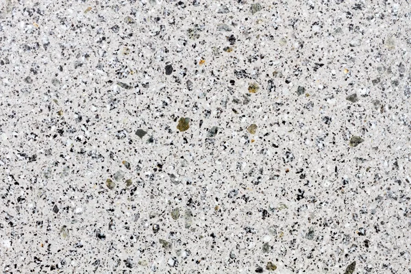 Vit glänsande granit struktur på en arbetade sten Stockbild