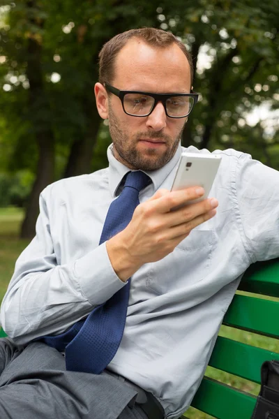Businessman holding cell phone — Stock Photo, Image