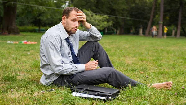 Young businessman on grass — Stock Photo, Image