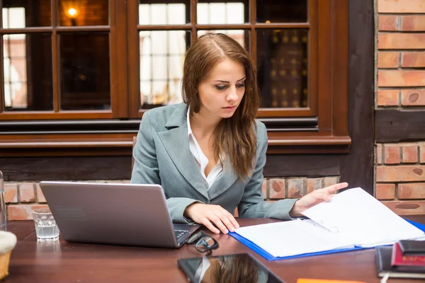 Hard working businesswoman in restaurant — Stock Photo, Image