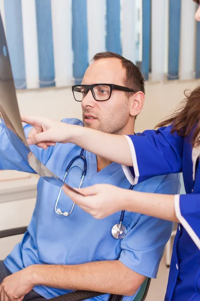 Doctors examing x-ray picture — Stock Photo, Image