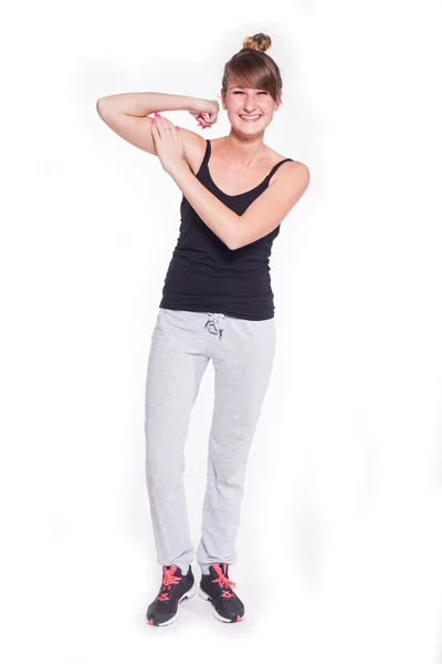 Adolescente menina flexionando seu bíceps — Fotografia de Stock