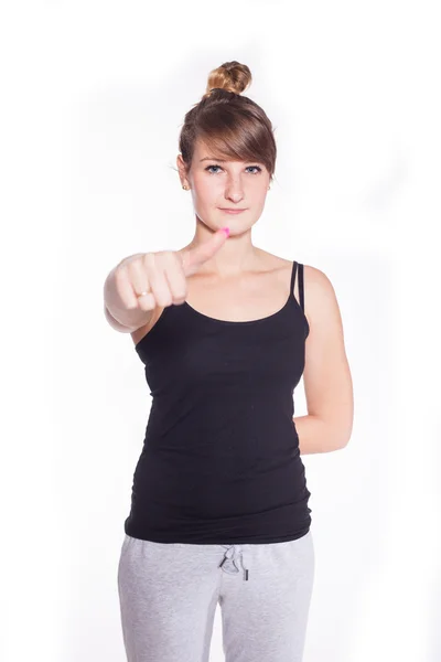Спортивная девушка показывает большой палец вверх Стоковое Изображение