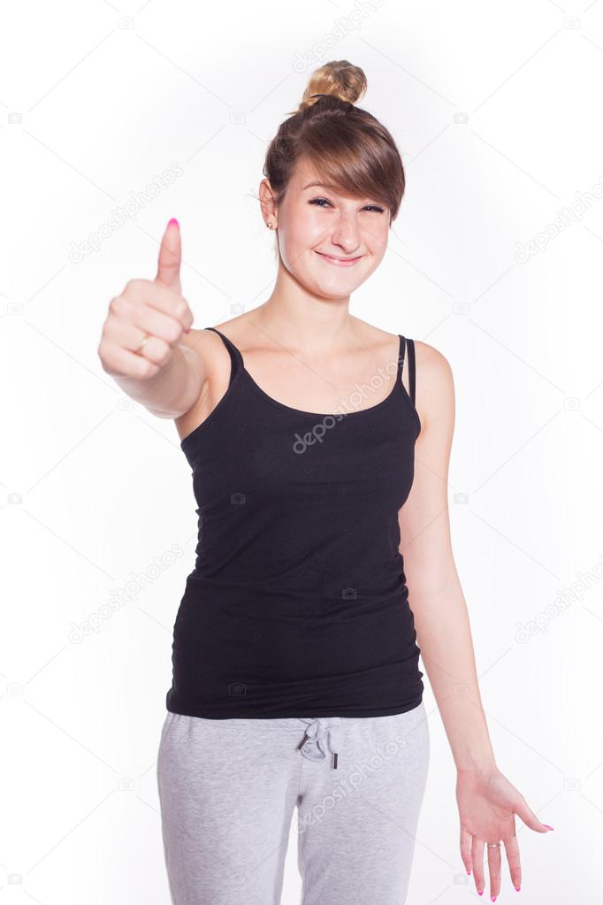 Sportive girl showing thumb up