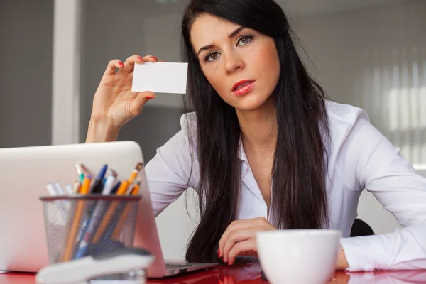 Businesswoman holding white business card