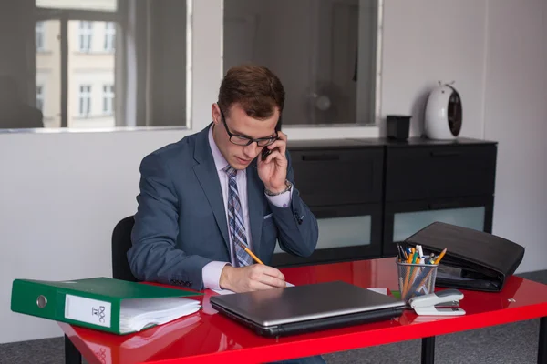 Businessman with laptop and mobile phone — Stock Photo, Image