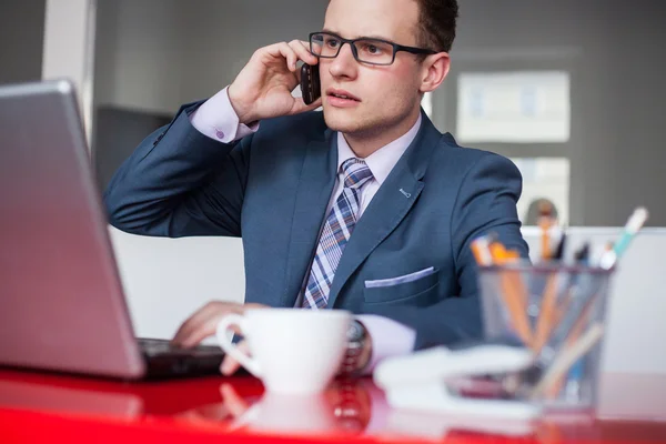 Businessman with laptop and mobile phone — Stock Photo, Image