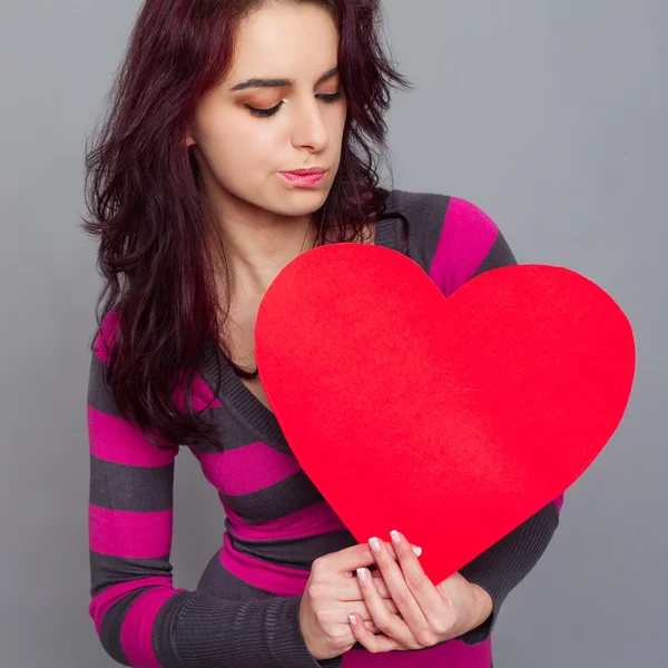 Girl holding paper heart Stock Picture