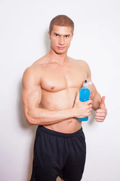 Muscular man with energy drink — Stock Photo, Image