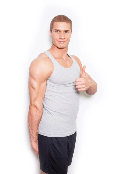 Muscled man showing thumb up — ストック写真