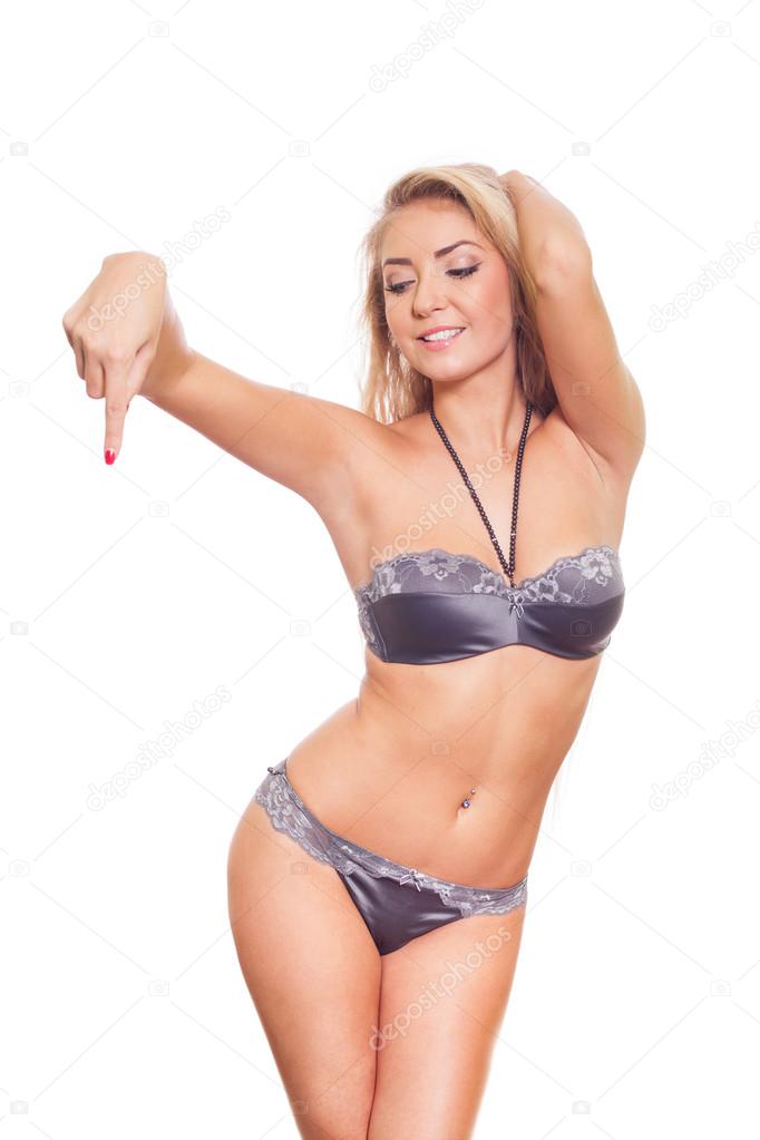 Model in lingerie pointing at copy space