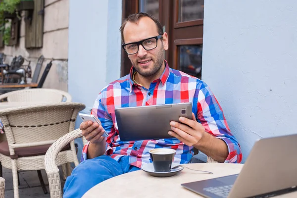 Tablet ve cep telefonu kullanan adam — Stok fotoğraf