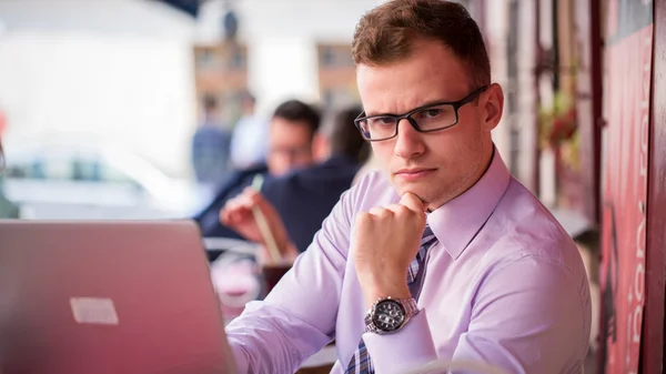 Serious businessman with laptop — Stock Photo, Image