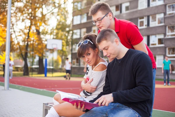 Students reading book — Stock Photo, Image