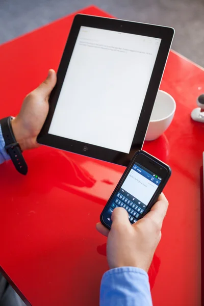 Businessman using tablet and mobile phone — Stock Photo, Image