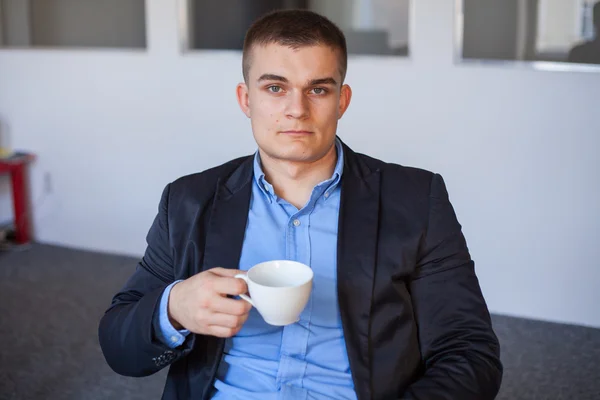 Affärsman anläggning kaffe kopp — Stockfoto