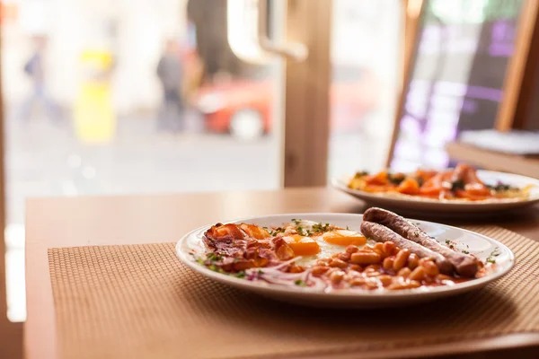 Ovos fritos, enchidos, feijões e bacon — Fotografia de Stock