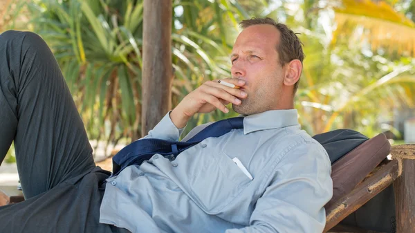 Businessman smoking — Stock Photo, Image