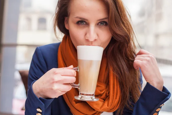 Girl drinking latte — Stock Photo, Image