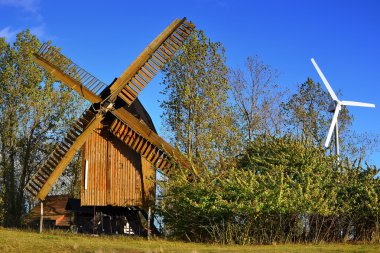 a historic windmill and a wind turbine clipart