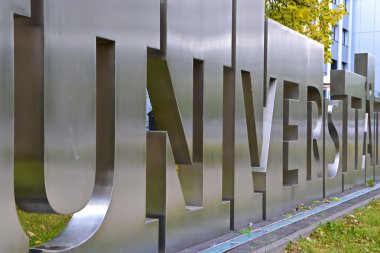 Metal lettering in front of a university clipart