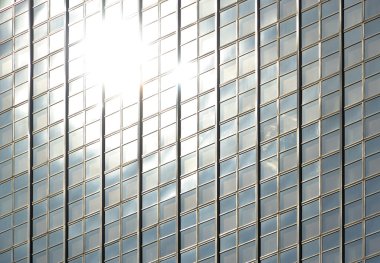 Glass facade with reflection of the sun clipart