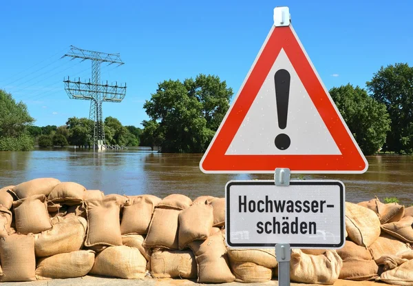 Sandbags and a warning sign — Stock Photo, Image