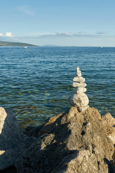 piled up stones and beautiful view of the Adriatic Sea near the town of Krk on the island of Krk in Croatia