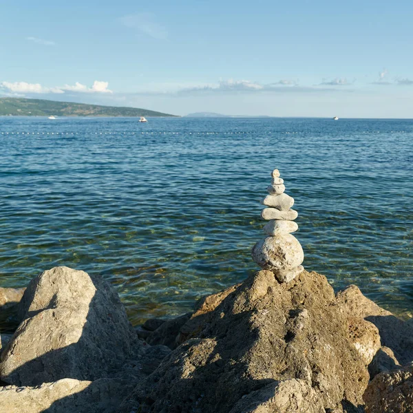 piled up stones and beautiful view of the Adriatic Sea near the town of Krk on the island of Krk in Croatia