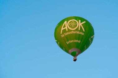  Magdeburg, Germany  July 23, 2022: Hot air balloon with advertisement for health insurance AOK in the sky of Magdeburg in Germany                              