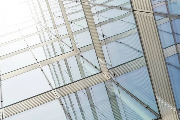 Glass facade of an office building with strong sunlight in the center of Berlin                               