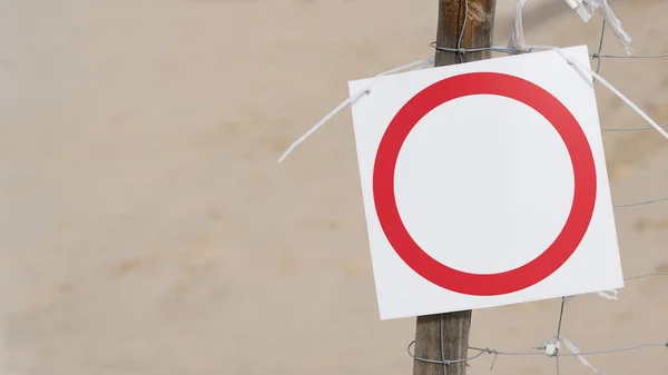Empty sign on the beach with copy space on the left and on the sign