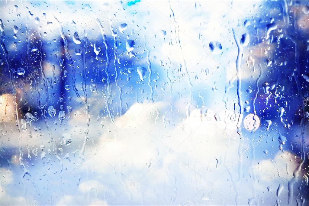 Rain running down glass window