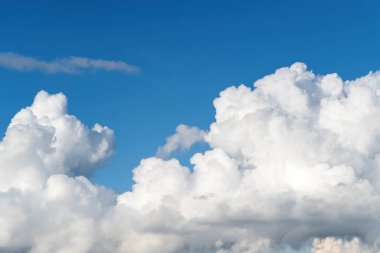 Blue sky with white and dark rainy clouds as background