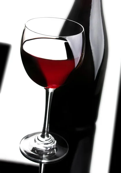 Red wine and black bottle — Stock Photo, Image