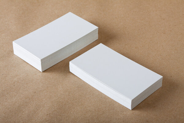 Blank business cards on crafts background.