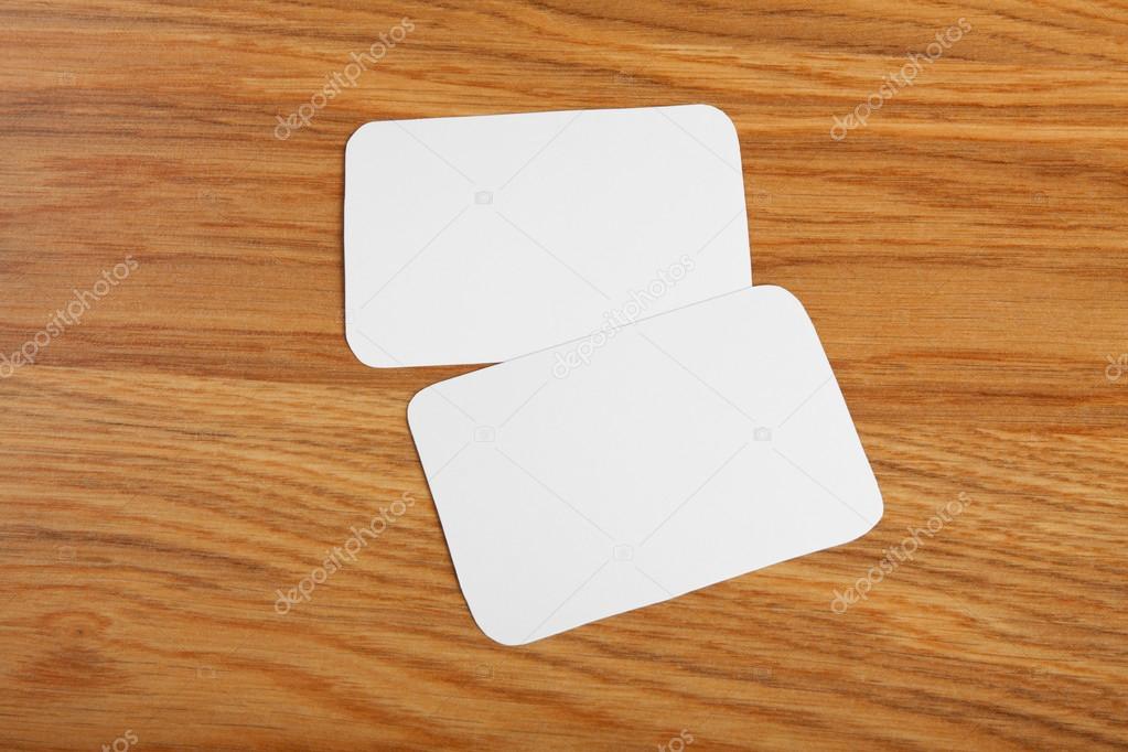 blank business cards with rounded corners on a wooden background