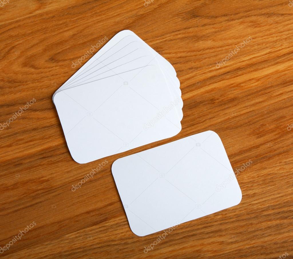 blank business cards with rounded corners on a wooden background
