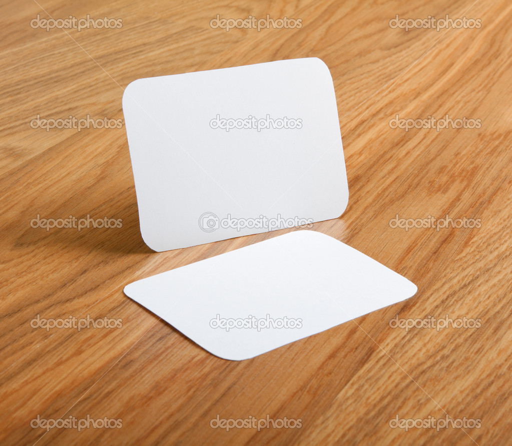  blank business cards with rounded corners on a wooden backgroun