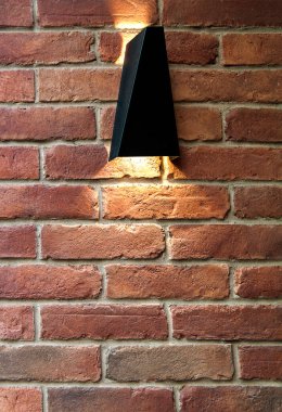 Parlak lamba ve ışınla tuğla duvar.