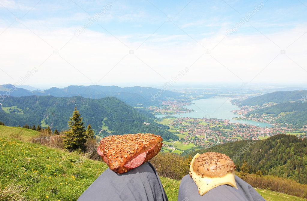 break at mountains peak with sandwiches and panoramic mountain view to lake tegernsee, germany